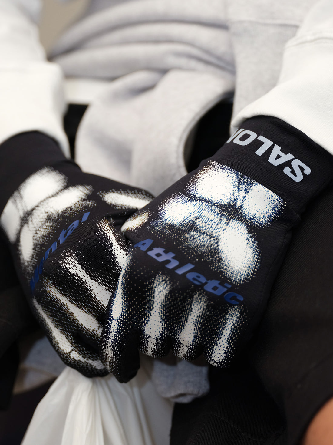 Close-up of Salomon branding on BURNT KNUCKLES GLOVES MENTAL ATHLETIC, ergonomic cuff design for secure fit during trail running