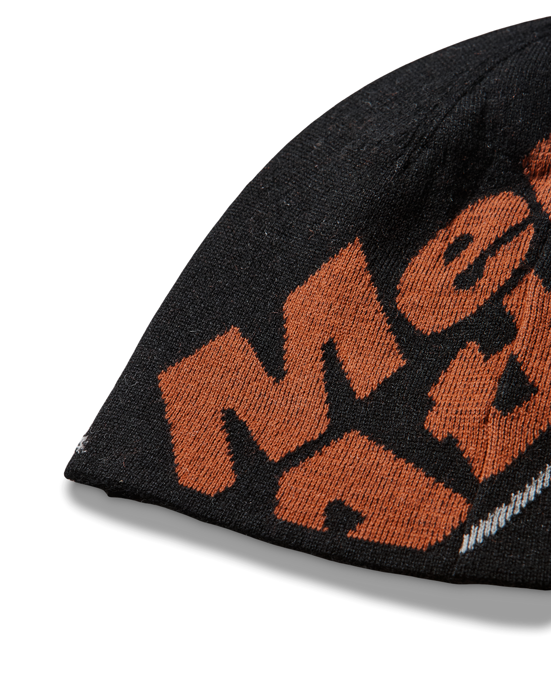 Close-up detail of the black beanie highlighting the orange knitted “Mental Athletic” logo.