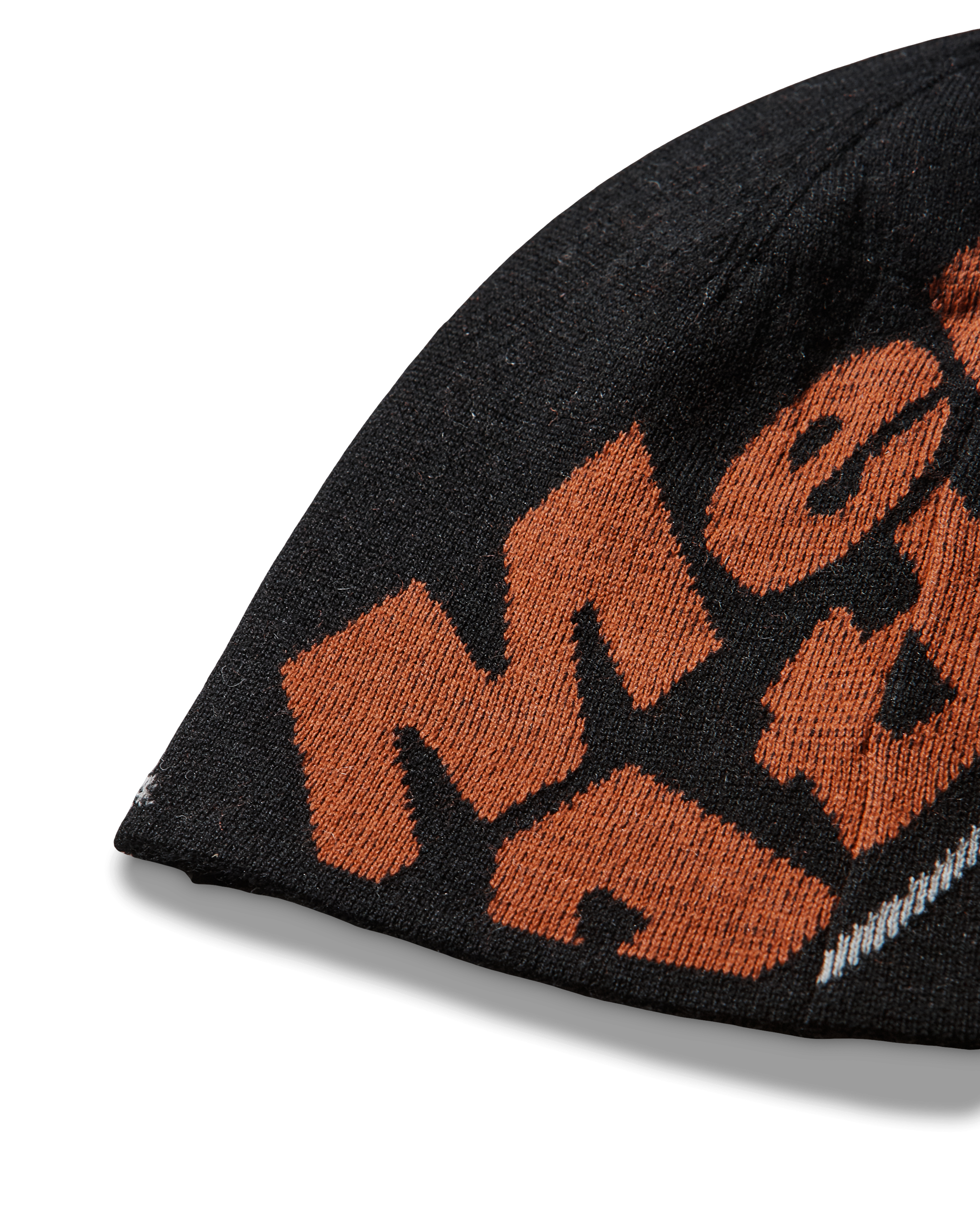 Close-up detail of the black beanie highlighting the orange knitted “Mental Athletic” logo.