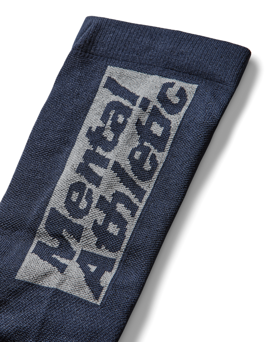 Close-up of the sock’s cuff displaying the “Mental Athletic” knitted logo in contrasting fibers.