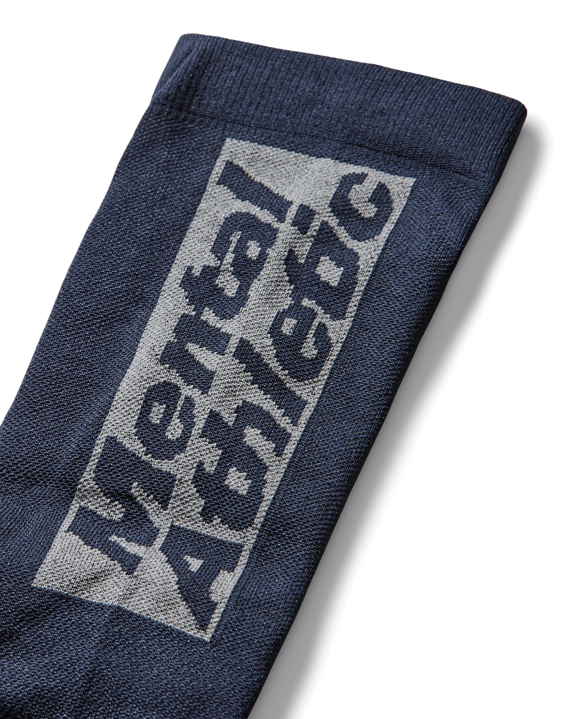 Close-up of the sock’s cuff displaying the “Mental Athletic” knitted logo in contrasting fibers.