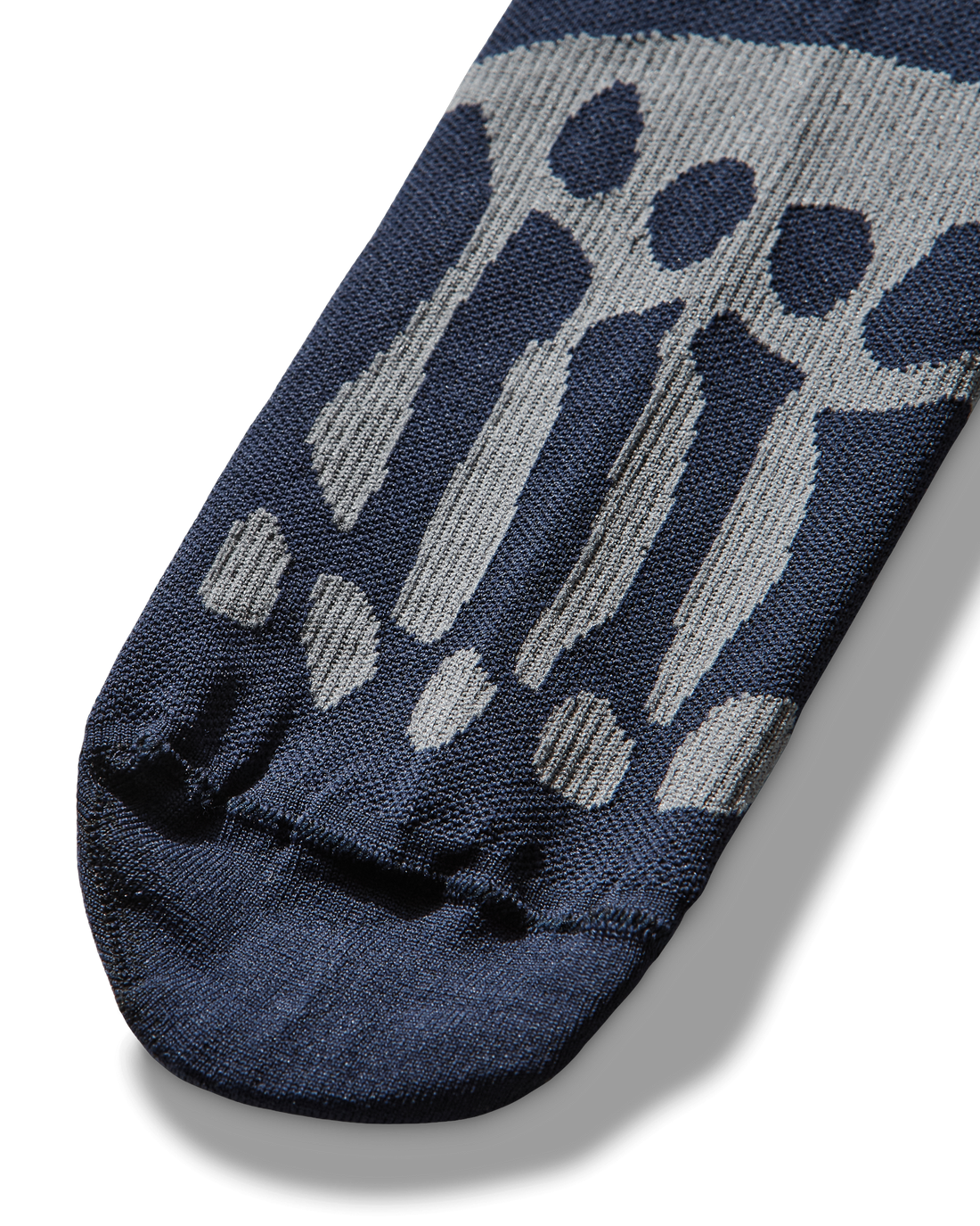 Detail of the toe area featuring the anatomical bone design knitted in light contrast yarn.