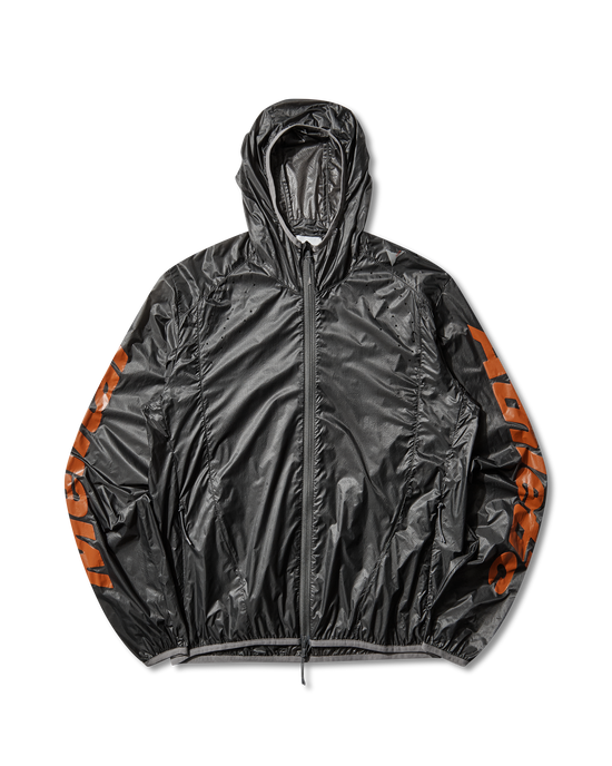 Front view of the black ROA x Mental Athletic Hue Packable Wind Jacket made from transparent micro ripstop nylon with orange logo details on the sleeves.