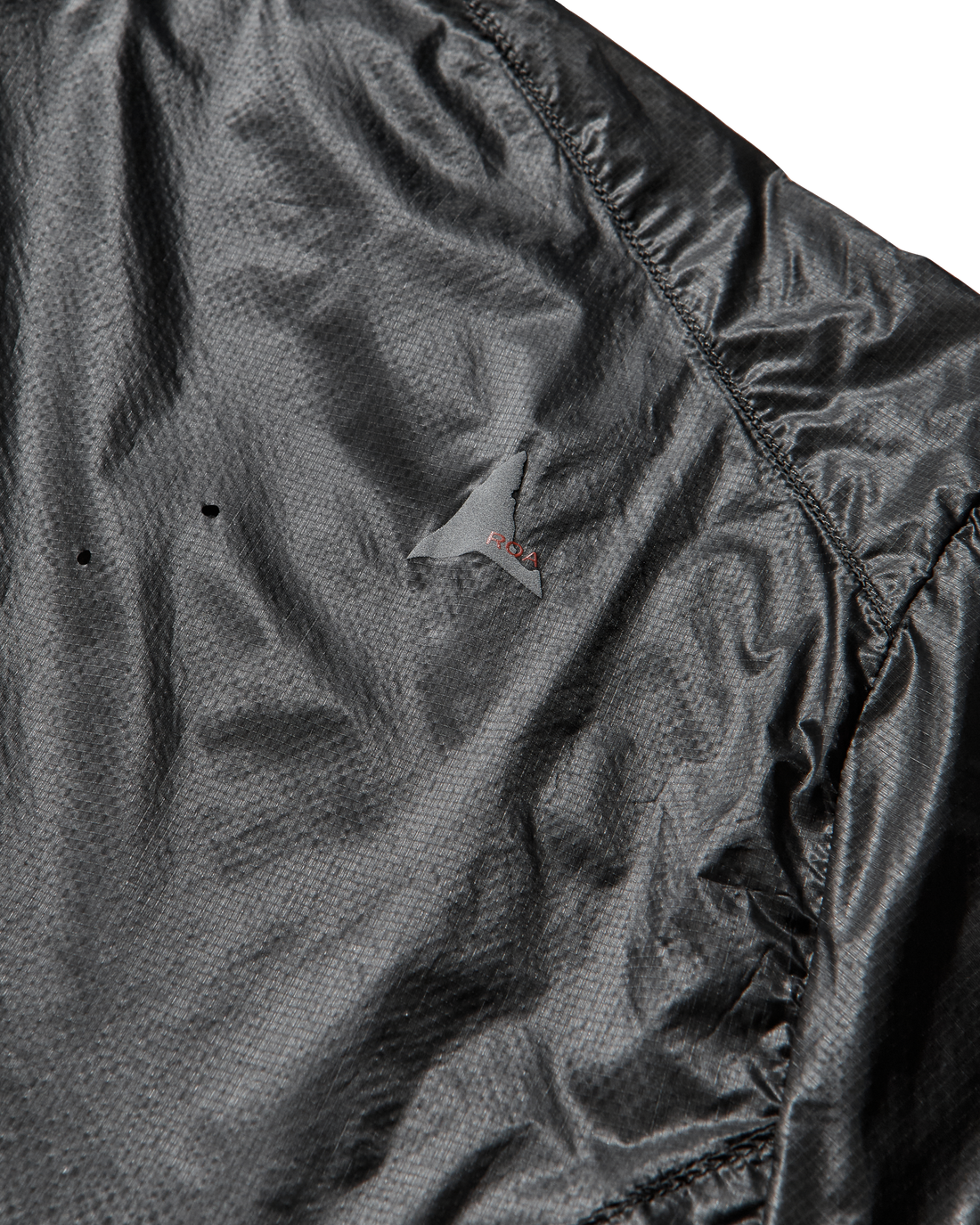 Close-up of the jacket’s side panel highlighting the transparent micro ripstop nylon and laser-cut detailing.