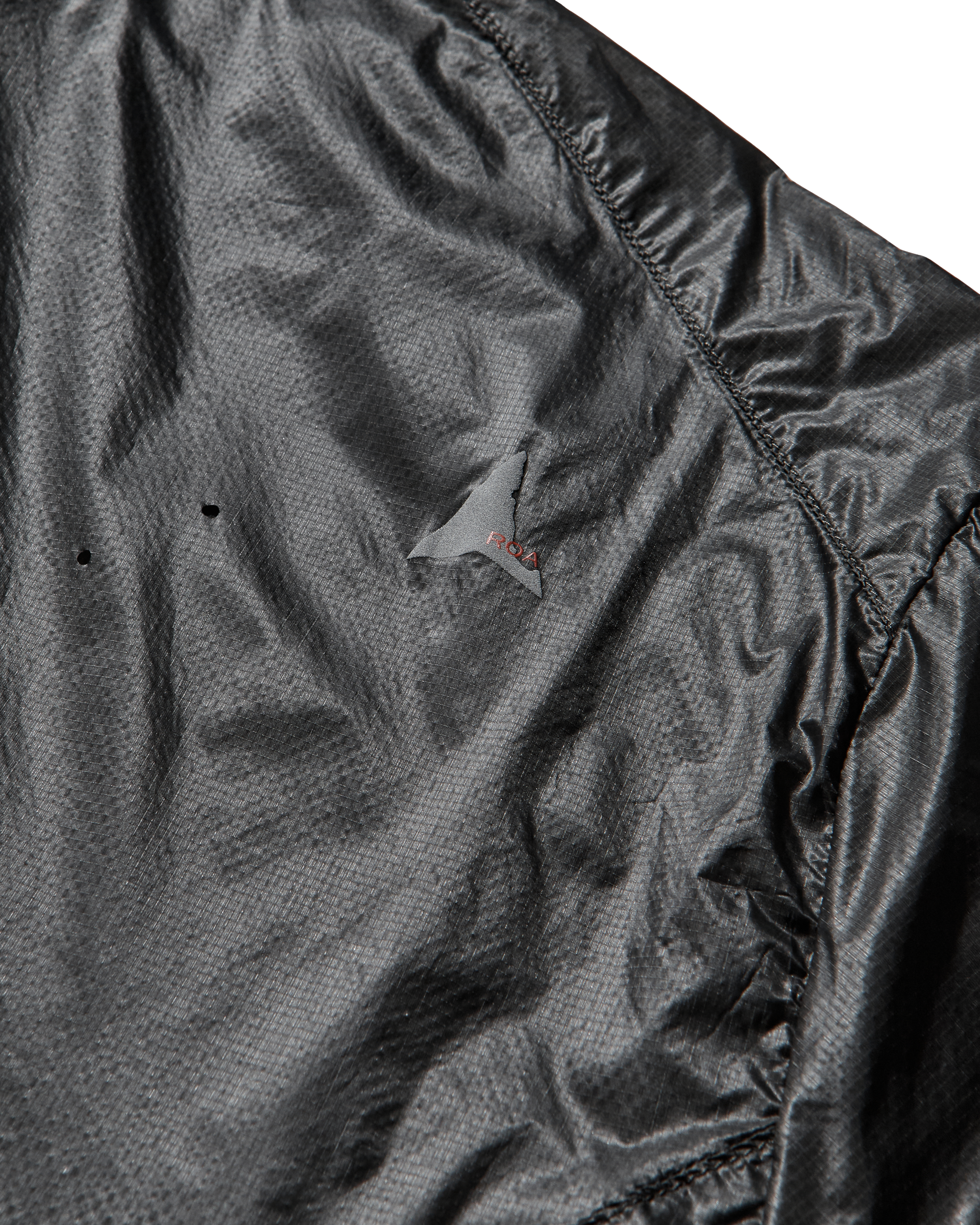 Close-up of the jacket’s side panel highlighting the transparent micro ripstop nylon and laser-cut detailing.