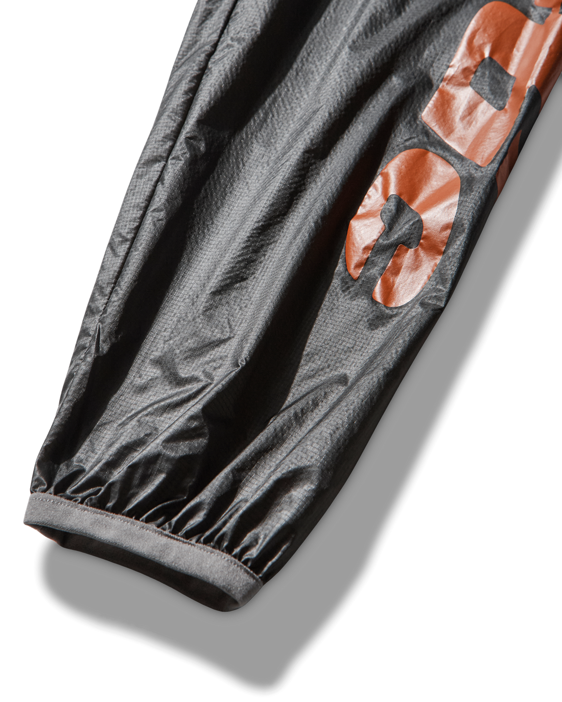 Close-up of the sleeve displaying the bold orange ROA x Mental Athletic printed logo.