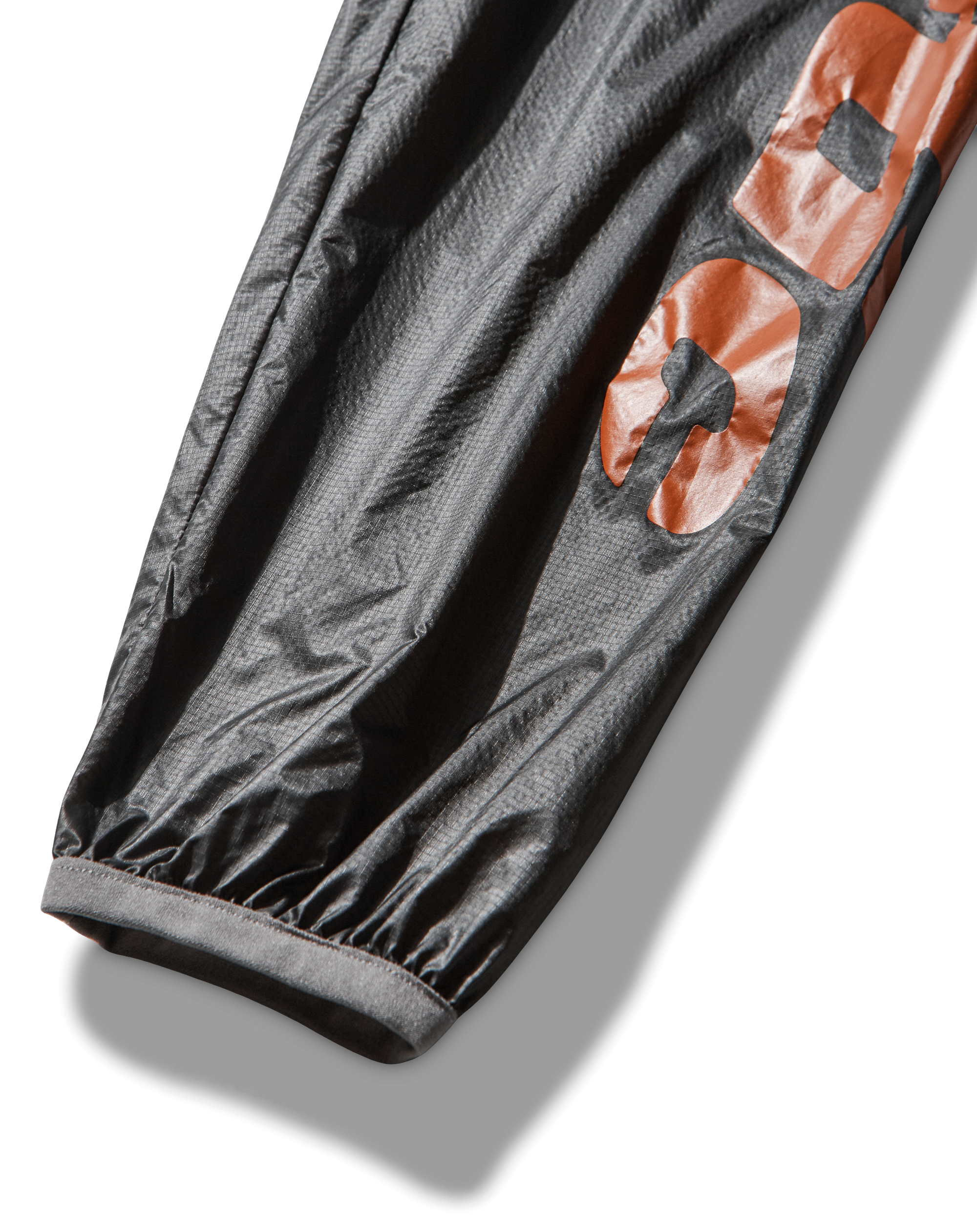 Close-up of the sleeve displaying the bold orange ROA x Mental Athletic printed logo.