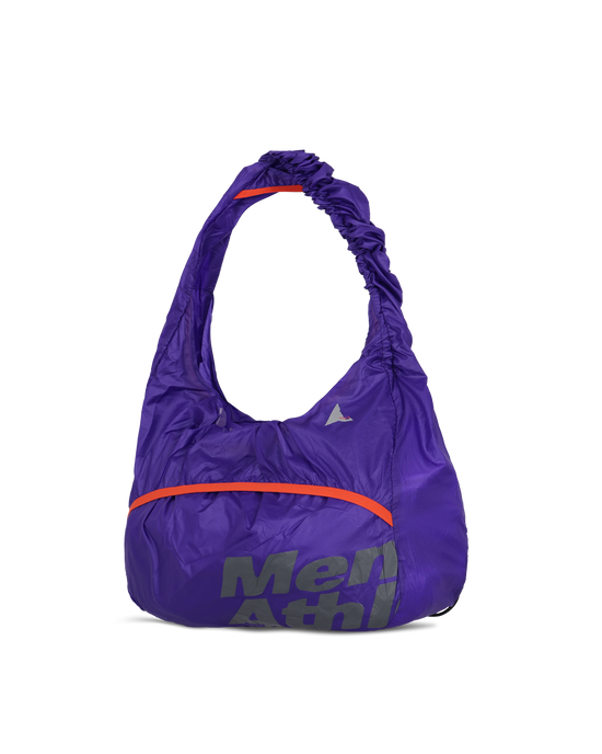 Side view of the purple ROA x Mental Athletic LAKI Packable Knot Bag showing the curved knot-style handle and front logo.