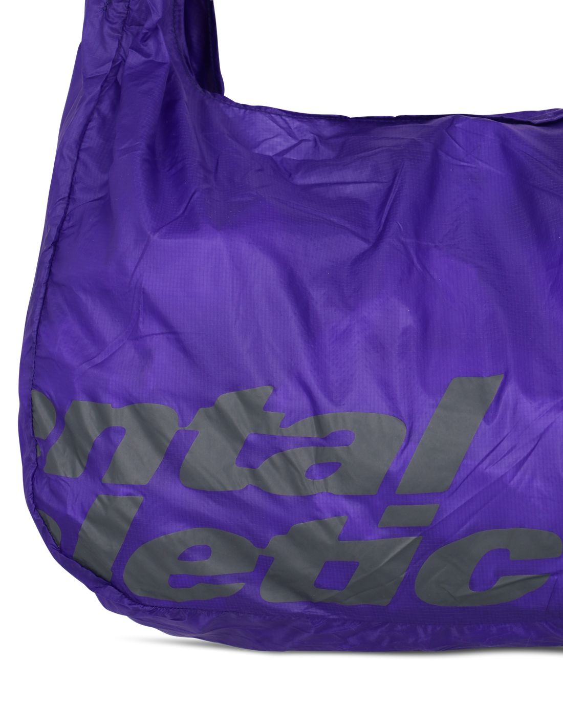 Close-up of the lower front section of the purple knot bag showing the Mental Athletic print and ripstop nylon texture.