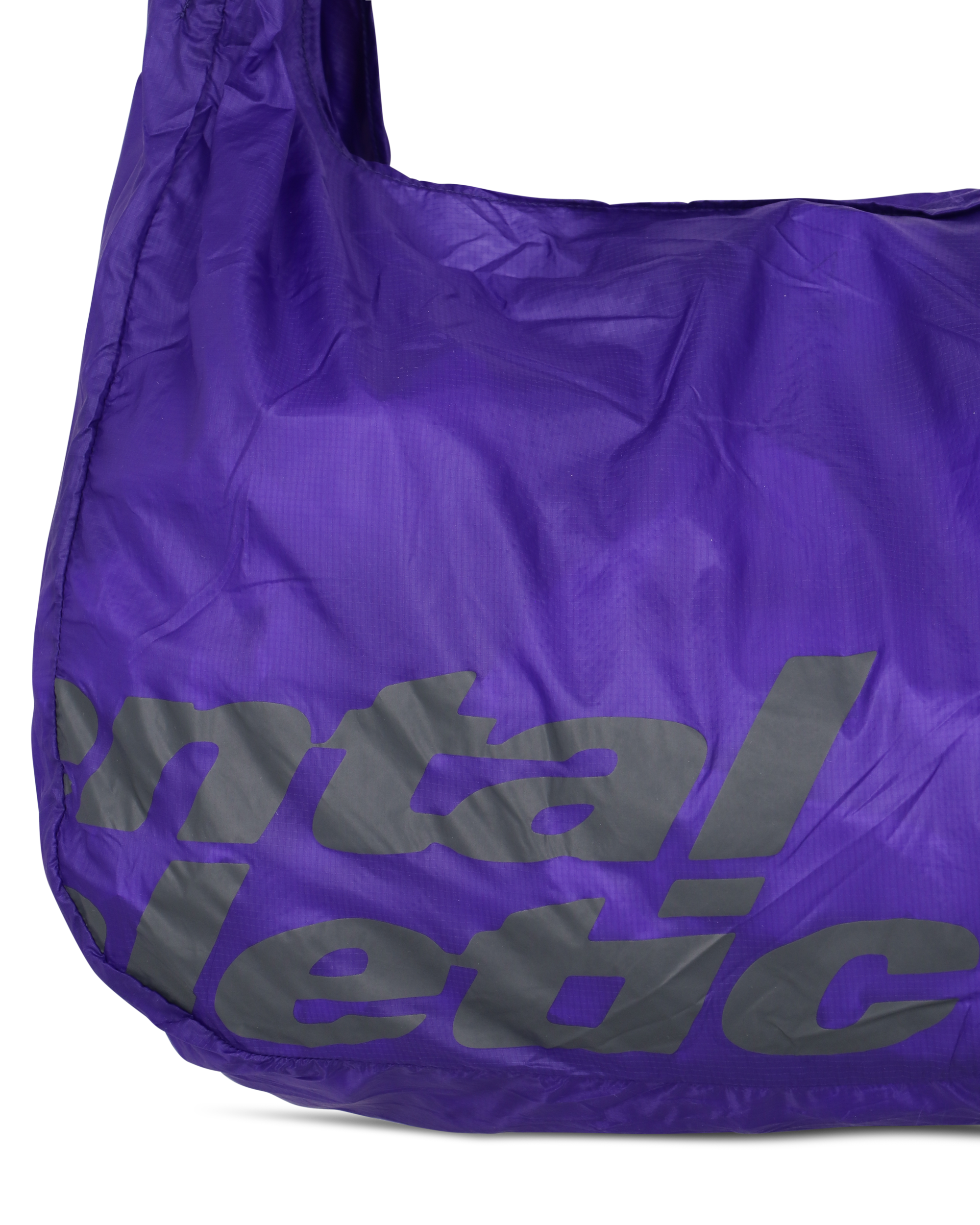 Close-up of the lower front section of the purple knot bag showing the Mental Athletic print and ripstop nylon texture.
