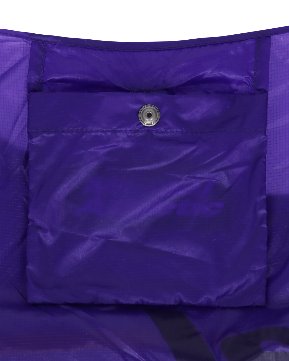 Interior view of the purple packable knot bag showcasing the inner pocket with snap closure.