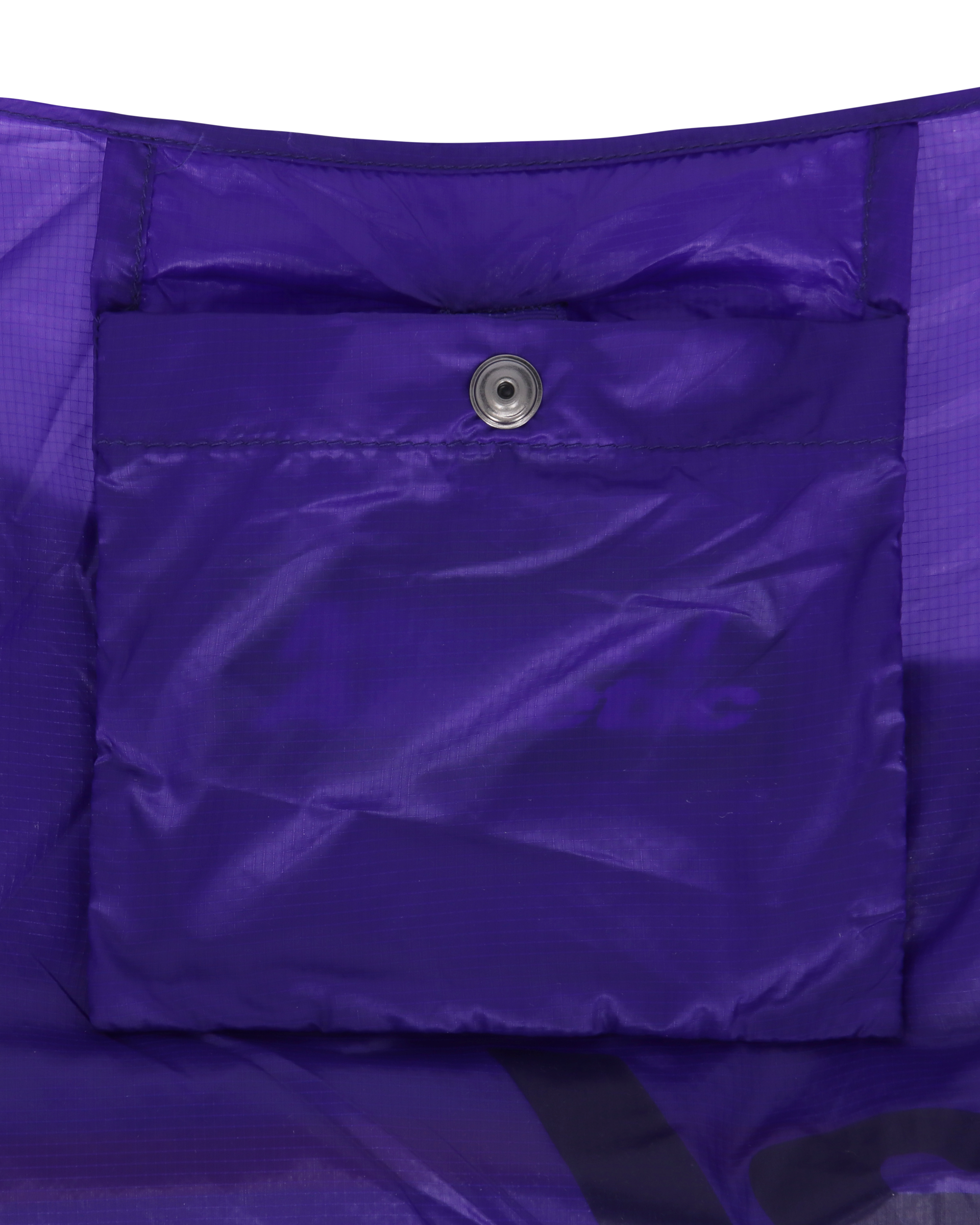 Interior view of the purple packable knot bag showcasing the inner pocket with snap closure.