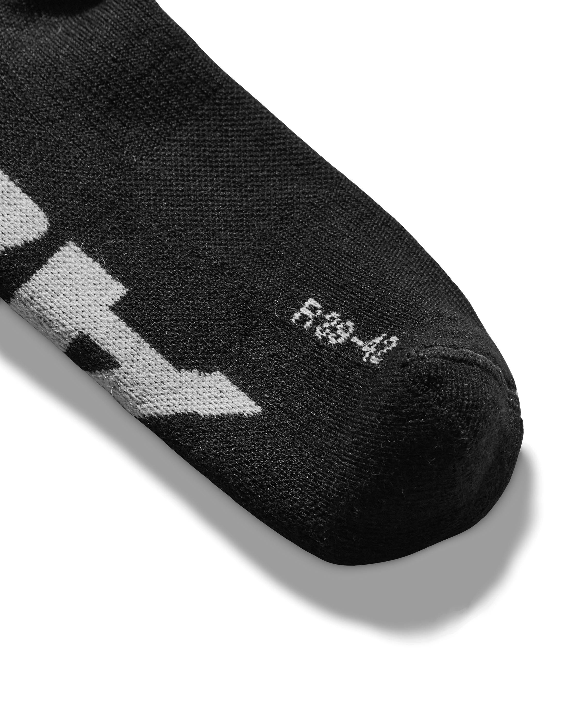 Toe detail: Close-up of sock toe with subtle blue logo detailing