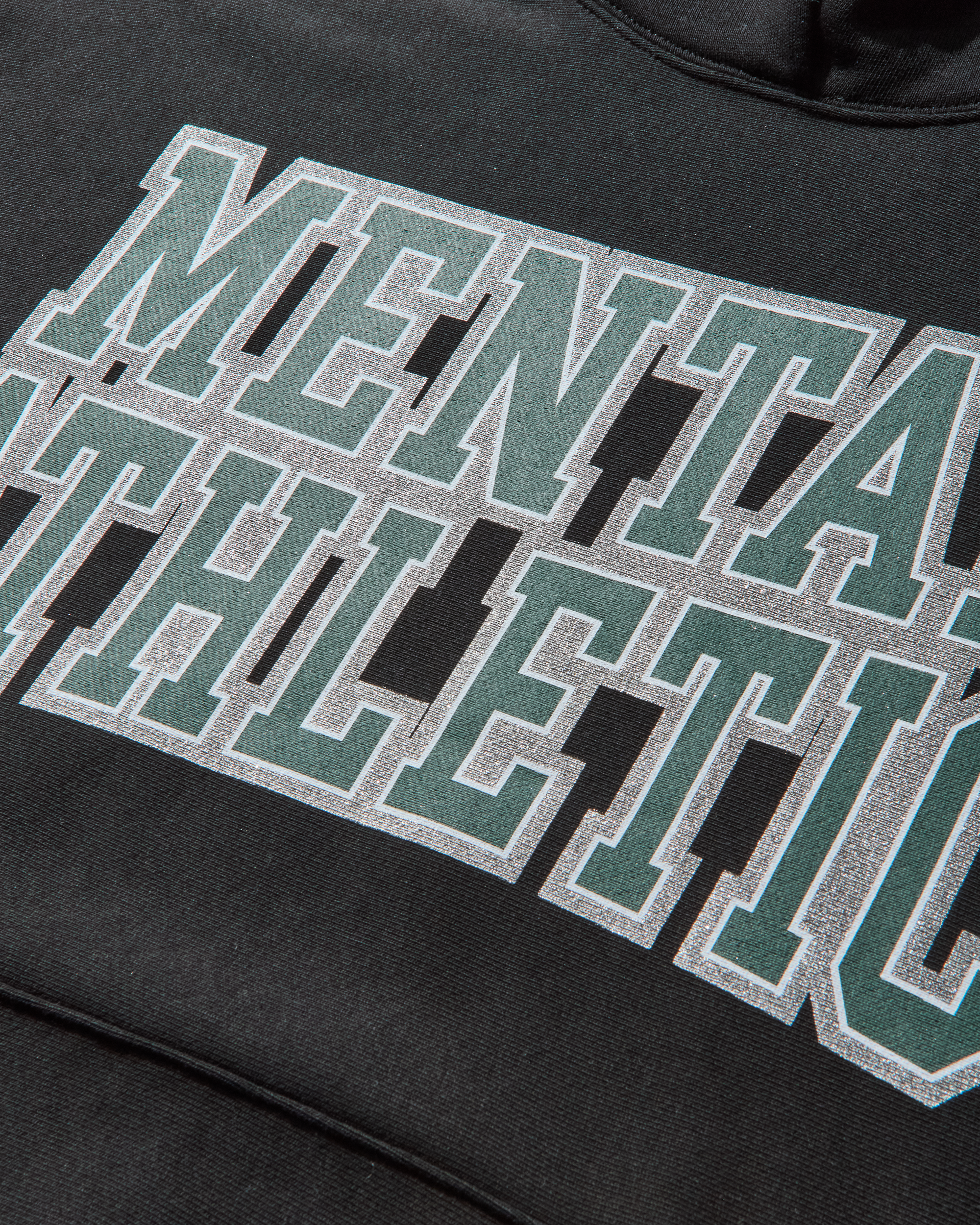 Close-up detail of COLLEGE HOODIE Mental Athletic logo print on premium cotton fabric.