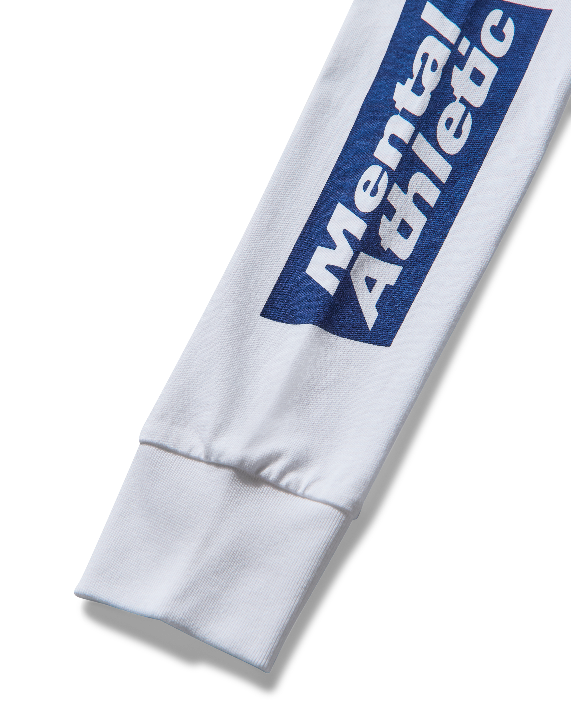 Close-up of sleeve monogram print and cotton texture.