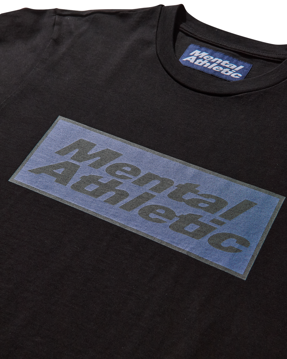 Close-up detail of logo print on Mental Athletic cotton sportswear tee.