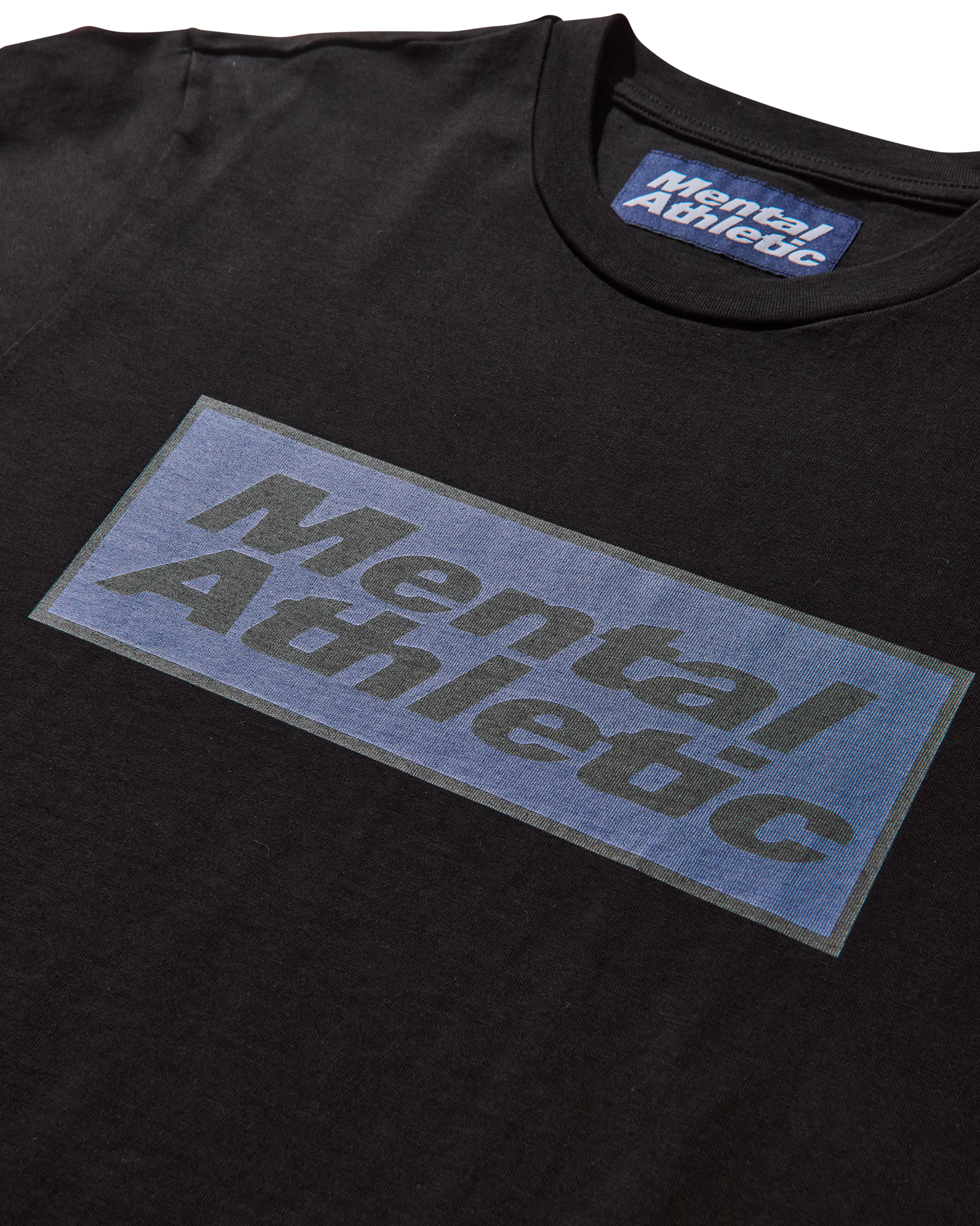 Close-up detail of logo print on Mental Athletic cotton sportswear tee.