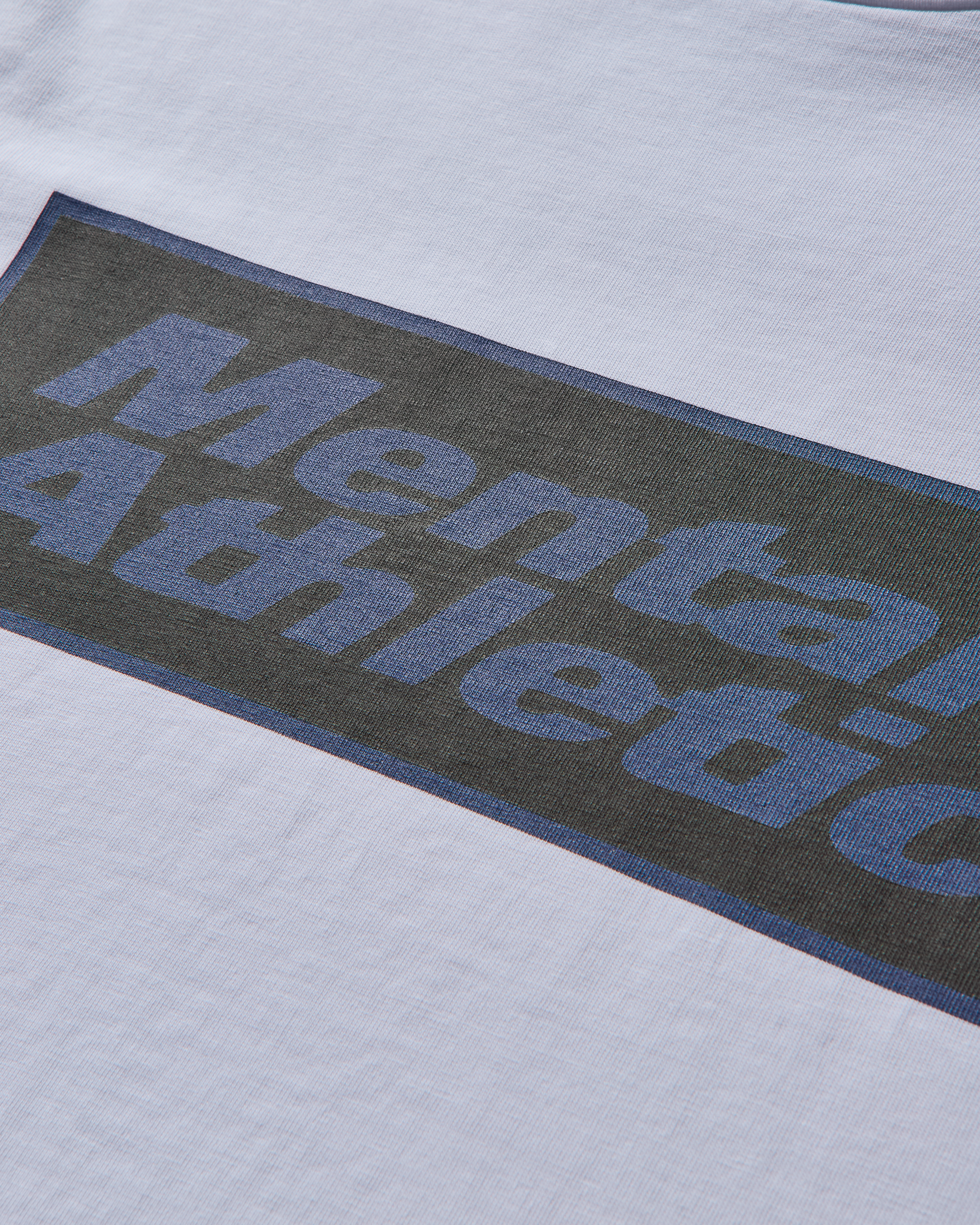 Close-up detail of logo print on Mental Athletic cotton sportswear tee.
