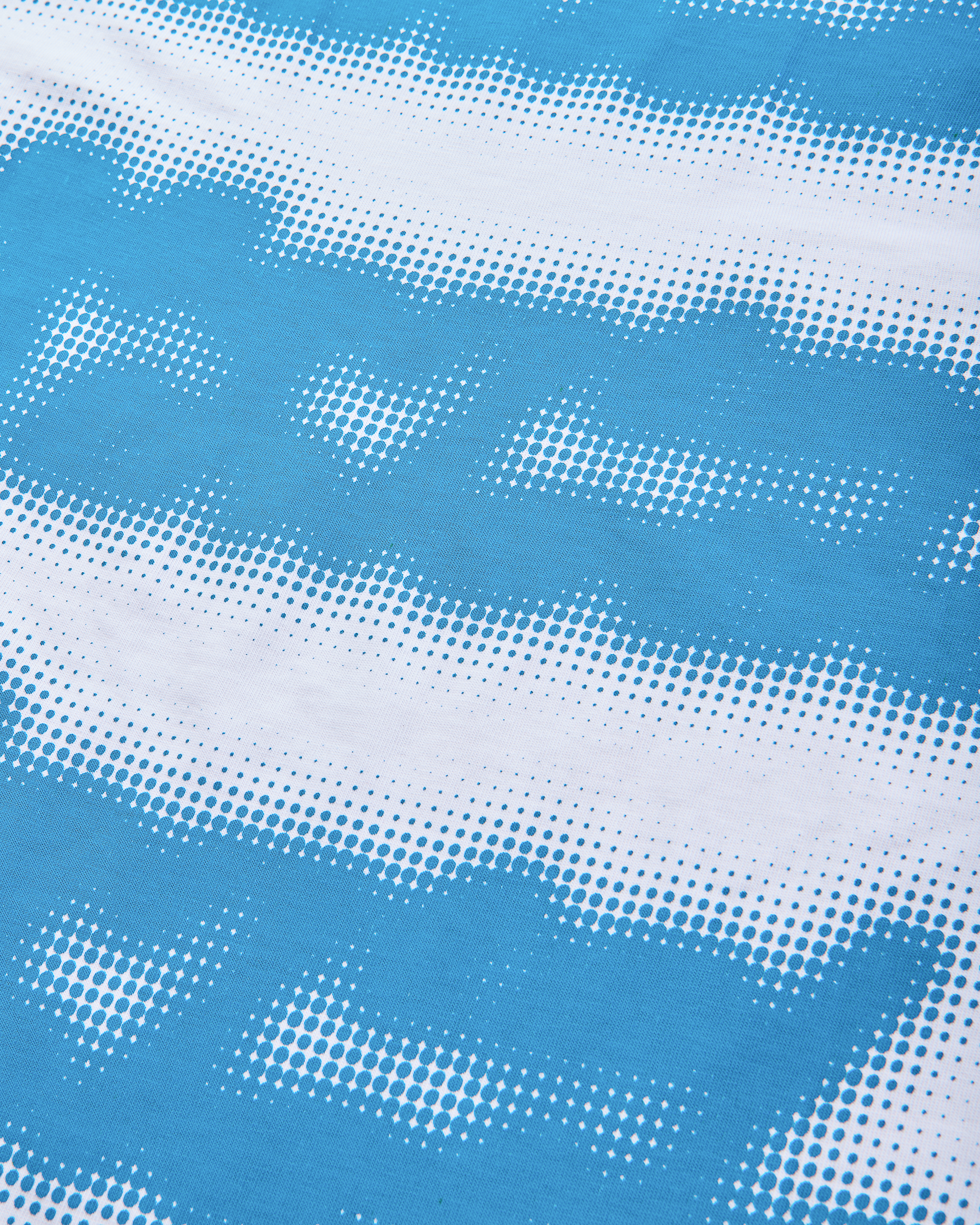 Mental Athletic white cotton t-shirt close-up of blue screenprint texture.