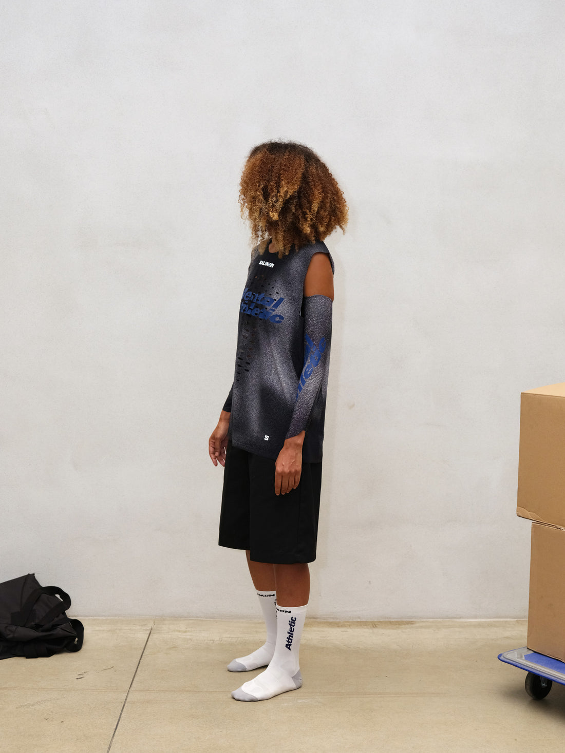 Model wearing WIND RUSH ARM SLEEVES Mental Athletic, full-body look styled for outdoor running and exploration.