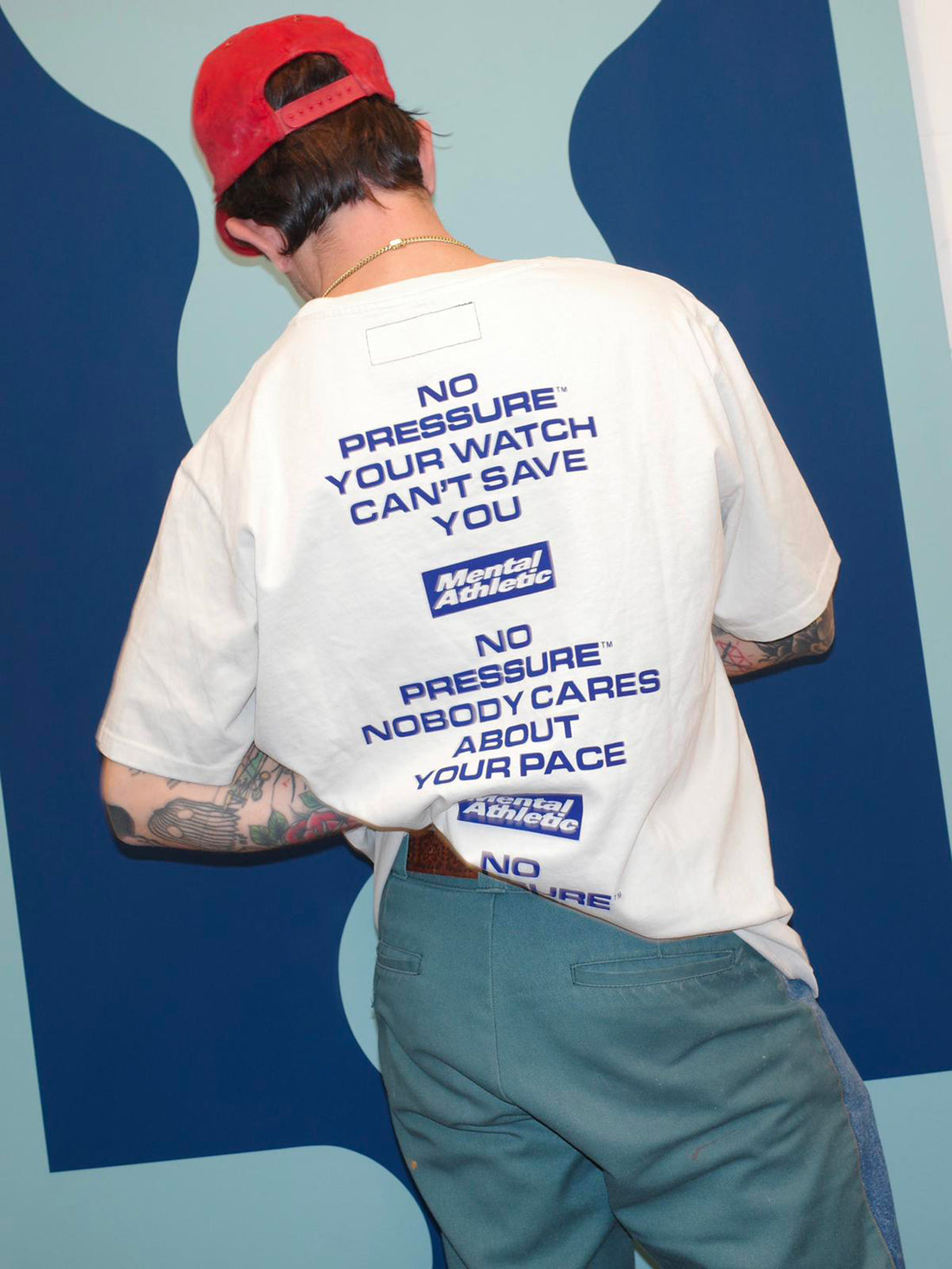 Mental Athletic x Pressure off-white t-shirt worn on body, back graphic visible.