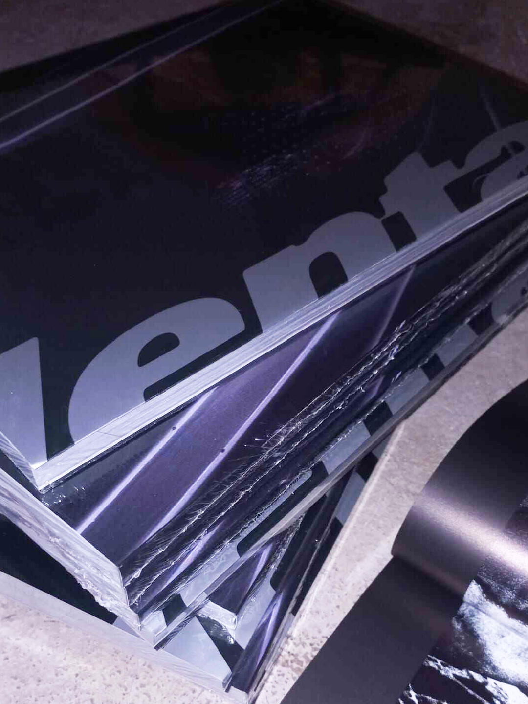 Close-up of printed typography on glossy paper, showing refined production details.