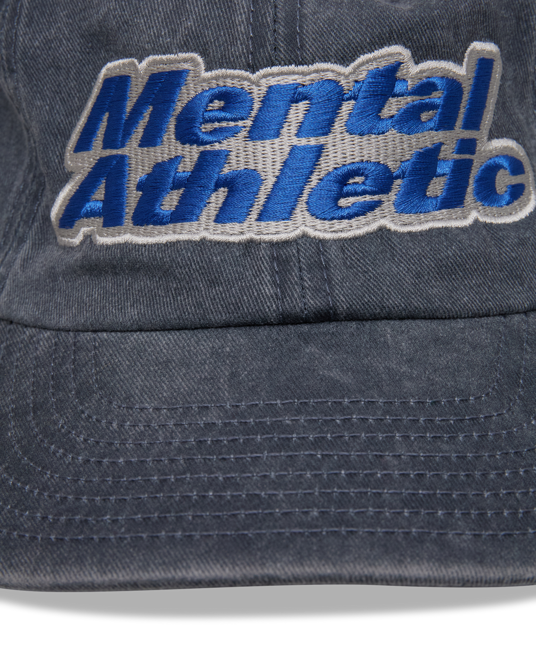 Mental Athletic washed blue cotton cap, close-up of blue “Mental Athletic” embroidery.