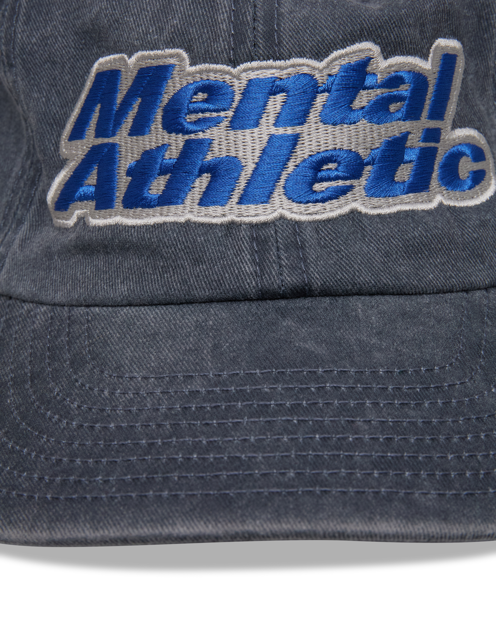 Mental Athletic washed blue cotton cap, close-up of blue “Mental Athletic” embroidery.