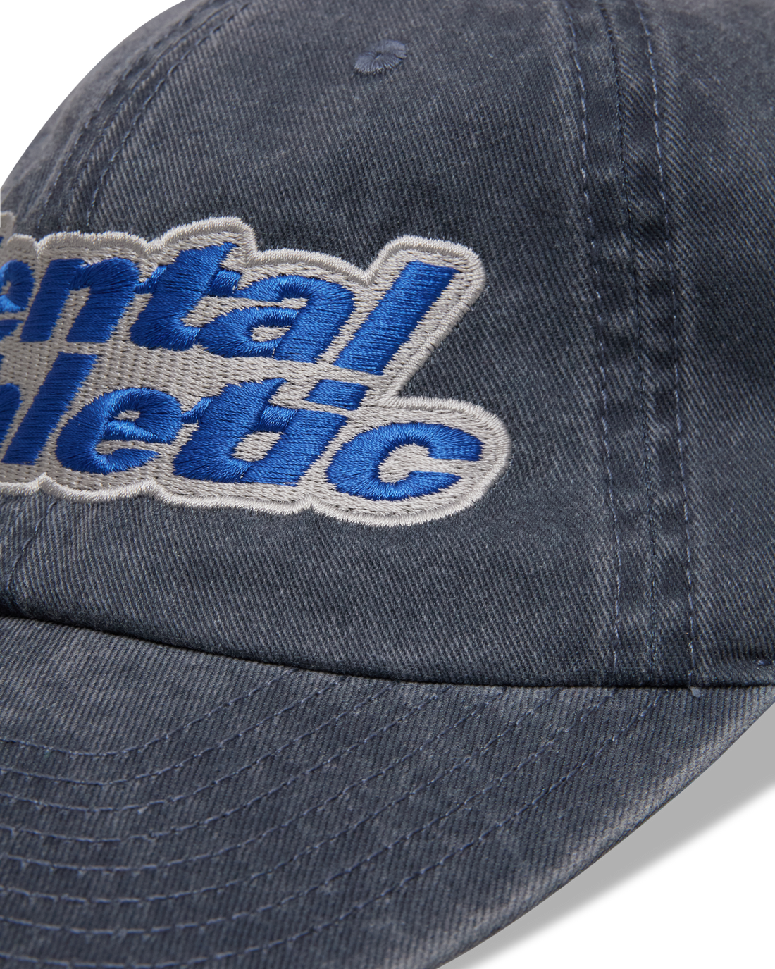 Mental Athletic washed blue cotton cap, close-up of curved brim and stitching.