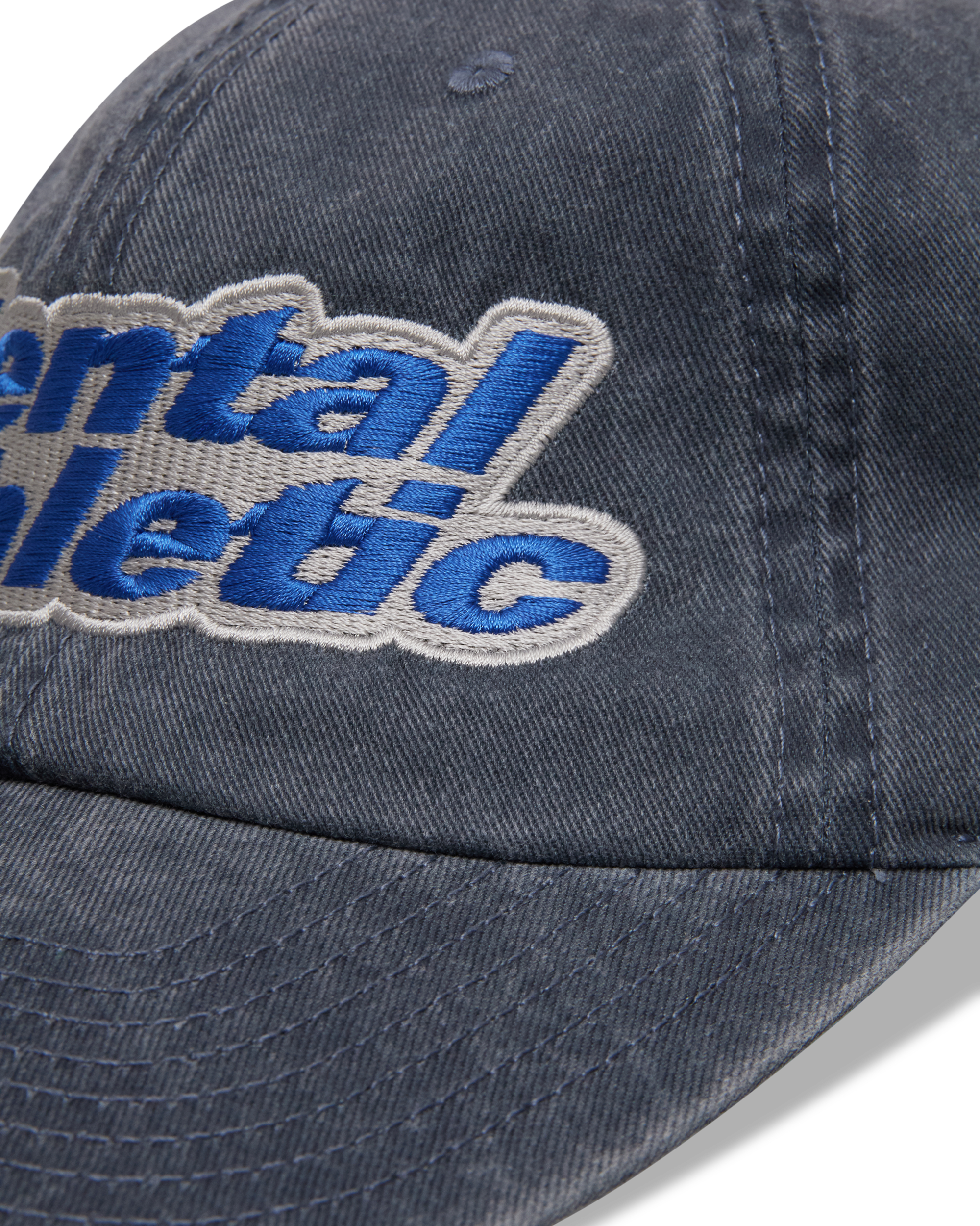 Mental Athletic washed blue cotton cap, close-up of curved brim and stitching.