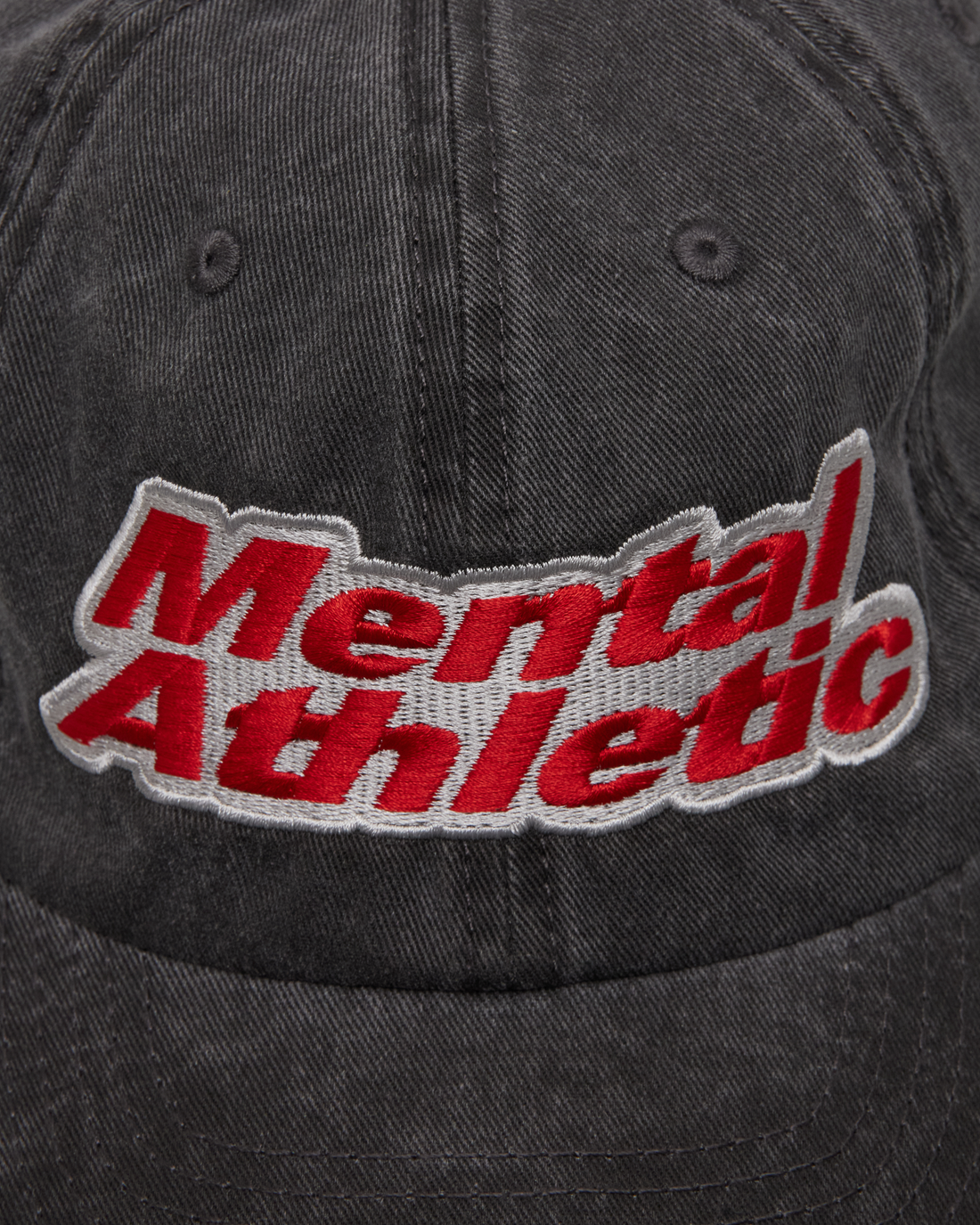 Mental Athletic washed black cotton cap, close-up of red “Mental Athletic” embroidery.