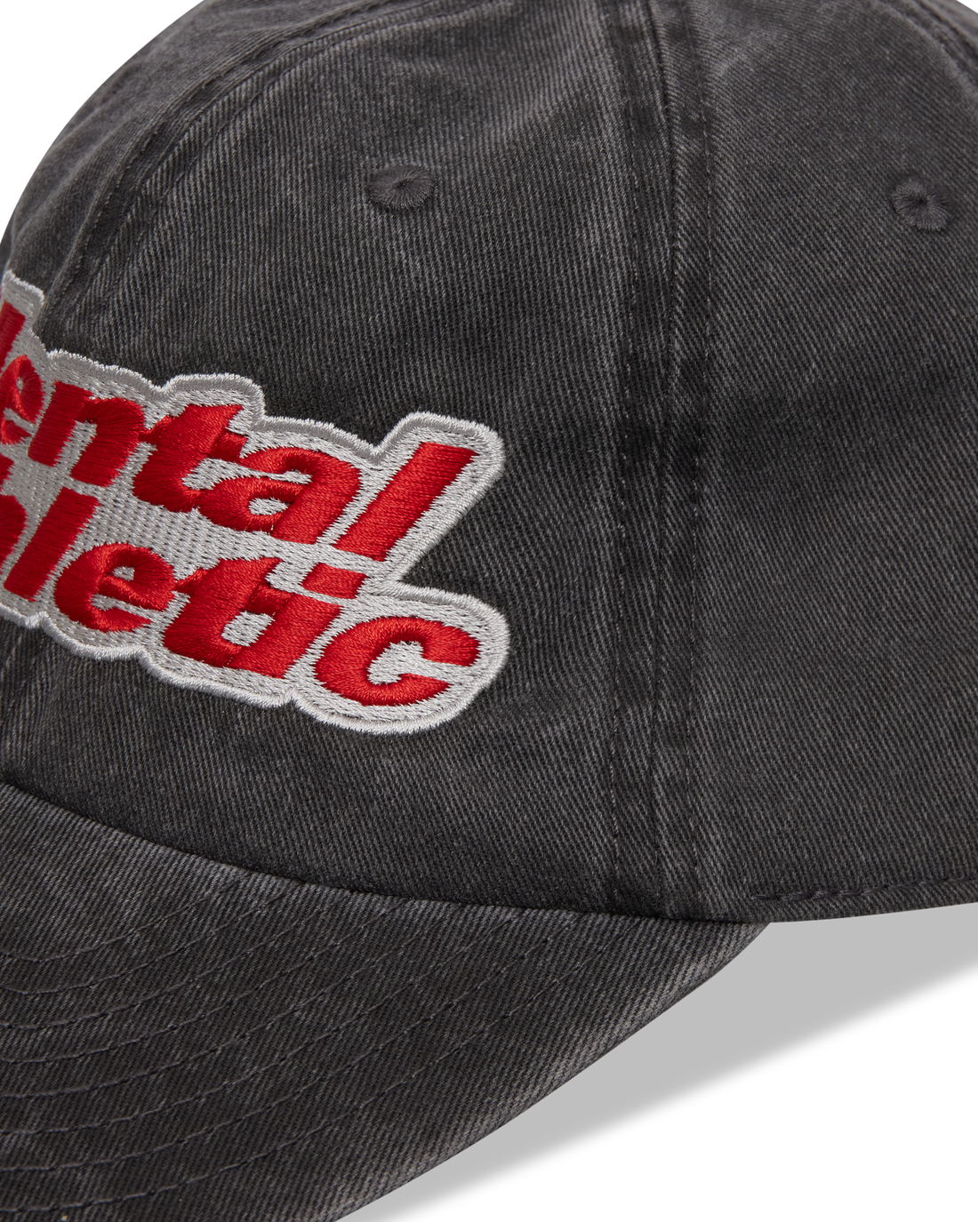 Mental Athletic washed black cotton cap, close-up of curved brim and stitching.