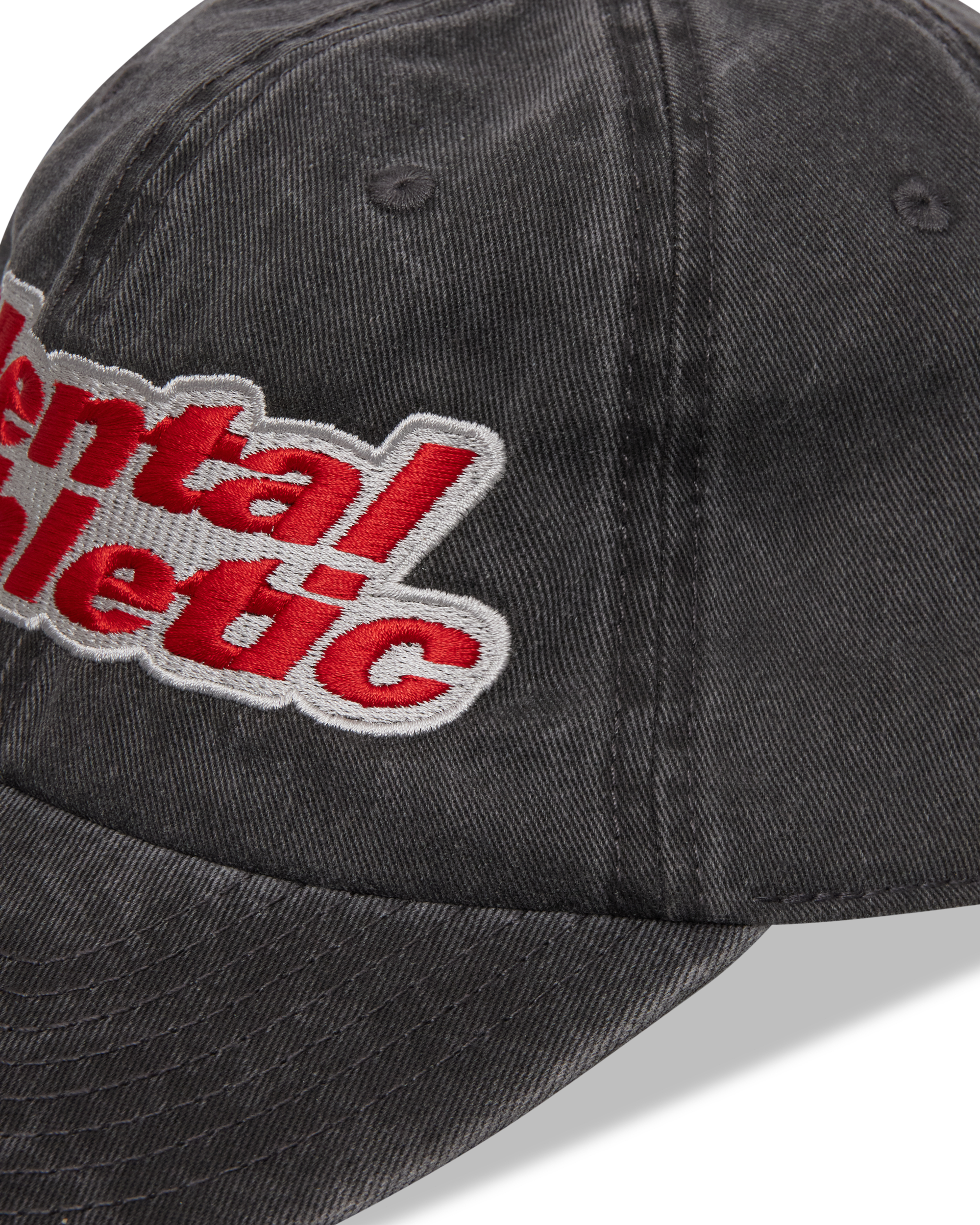 Mental Athletic washed black cotton cap, close-up of curved brim and stitching.