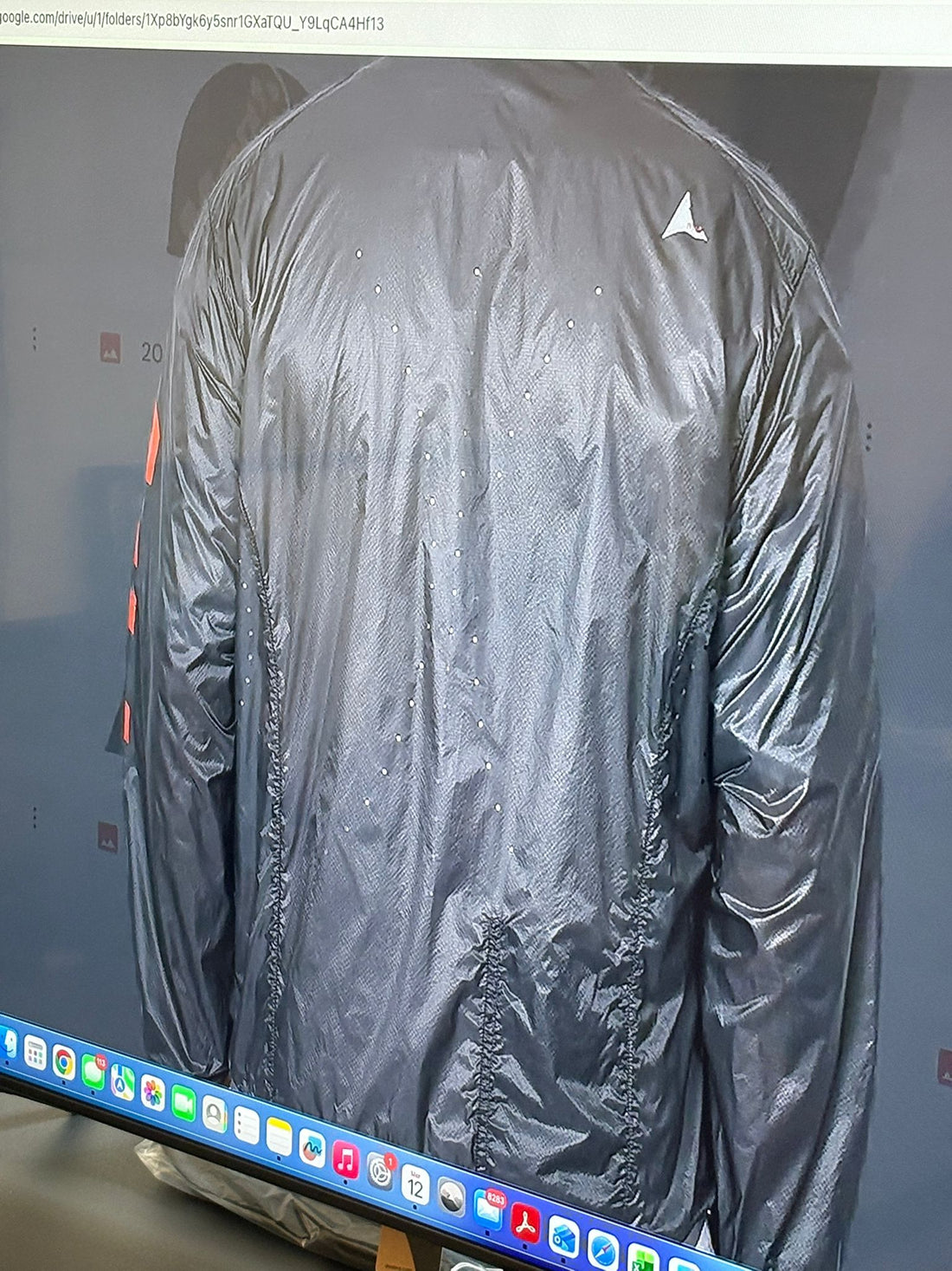 Close-up of the hood and shoulder area while worn, showing fabric translucency and construction details.