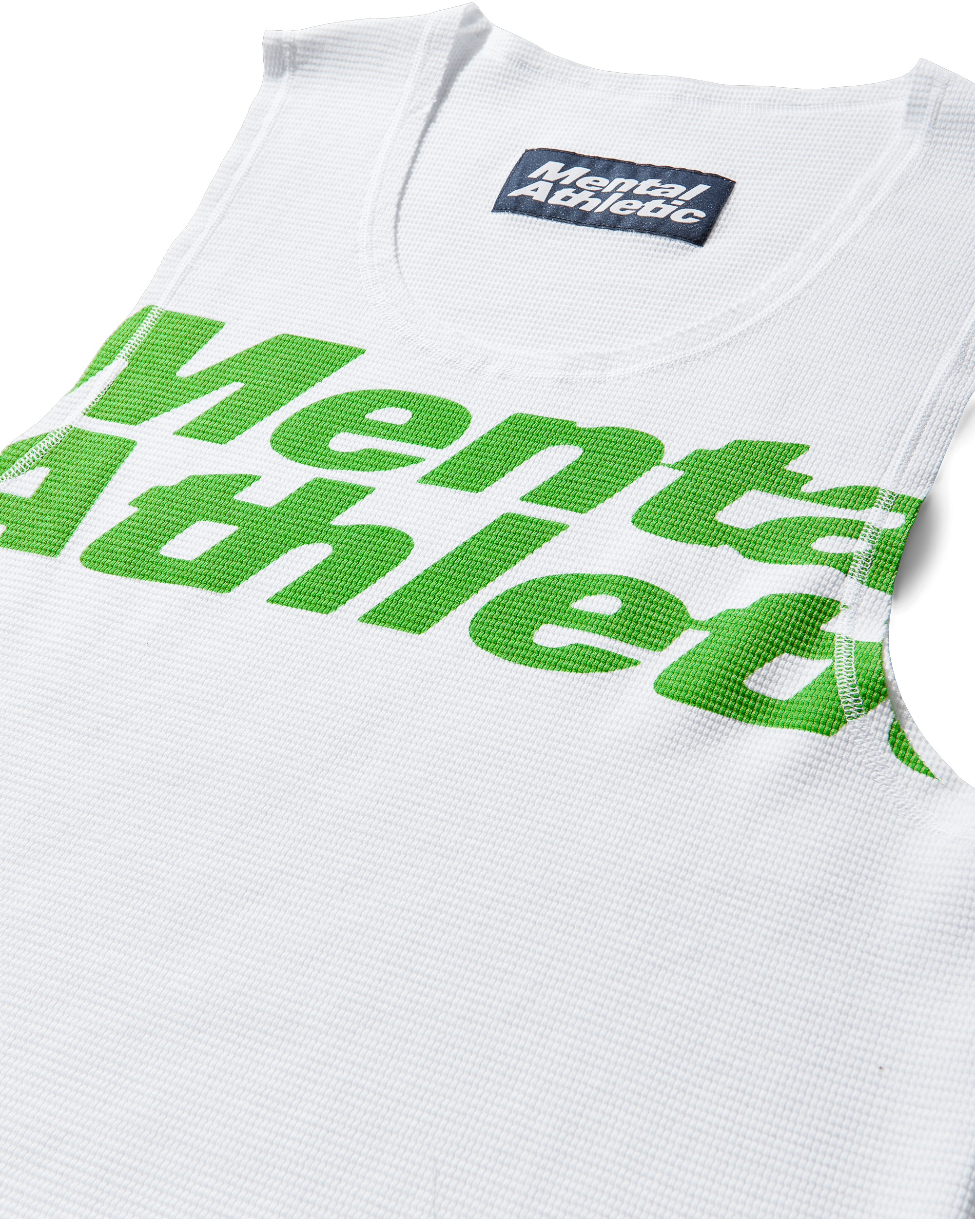Mental Athletic white cotton tank top close-up of green overlogo print.