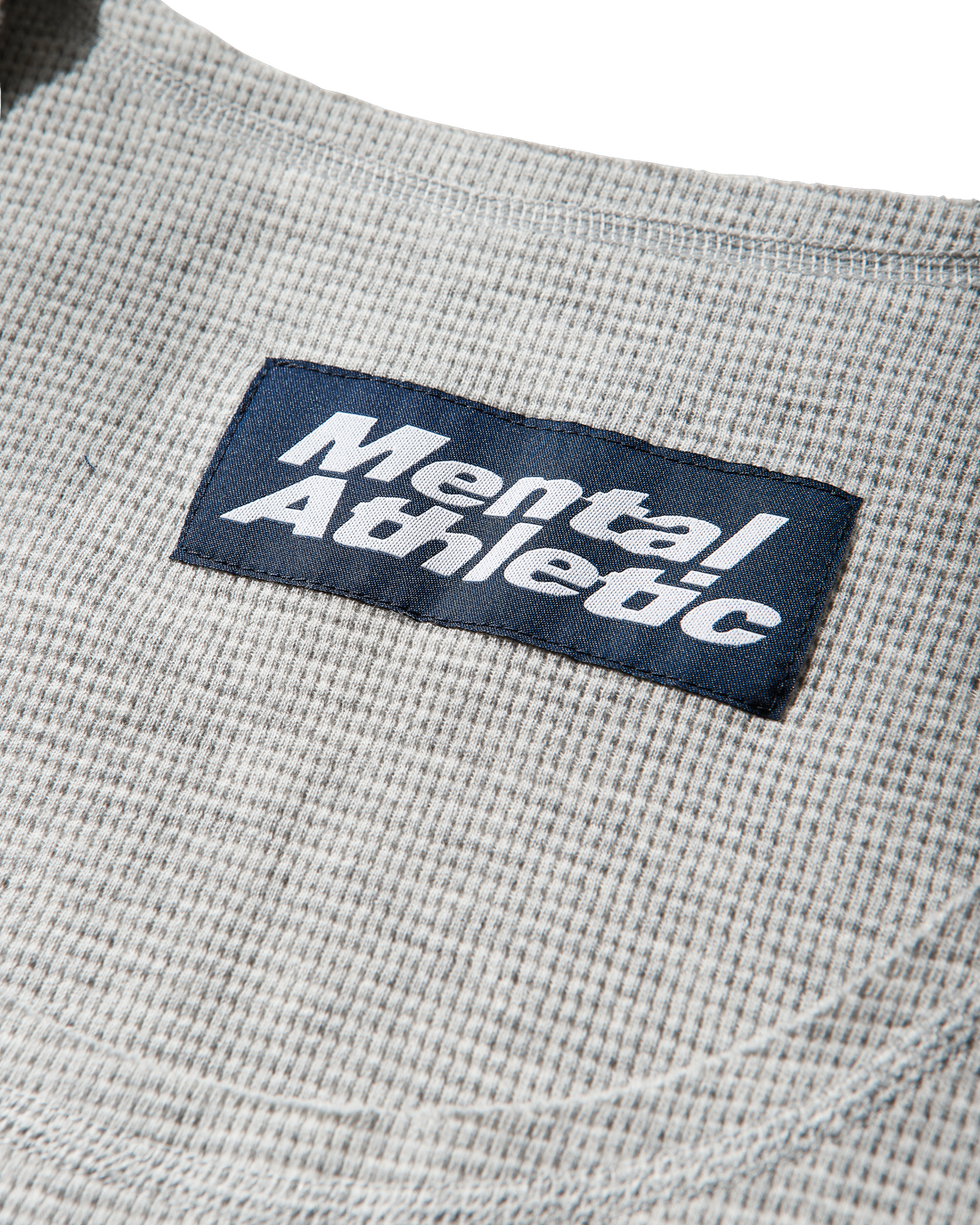 Mental Athletic grey cotton tank top detail of waffle fabric and woven label.
