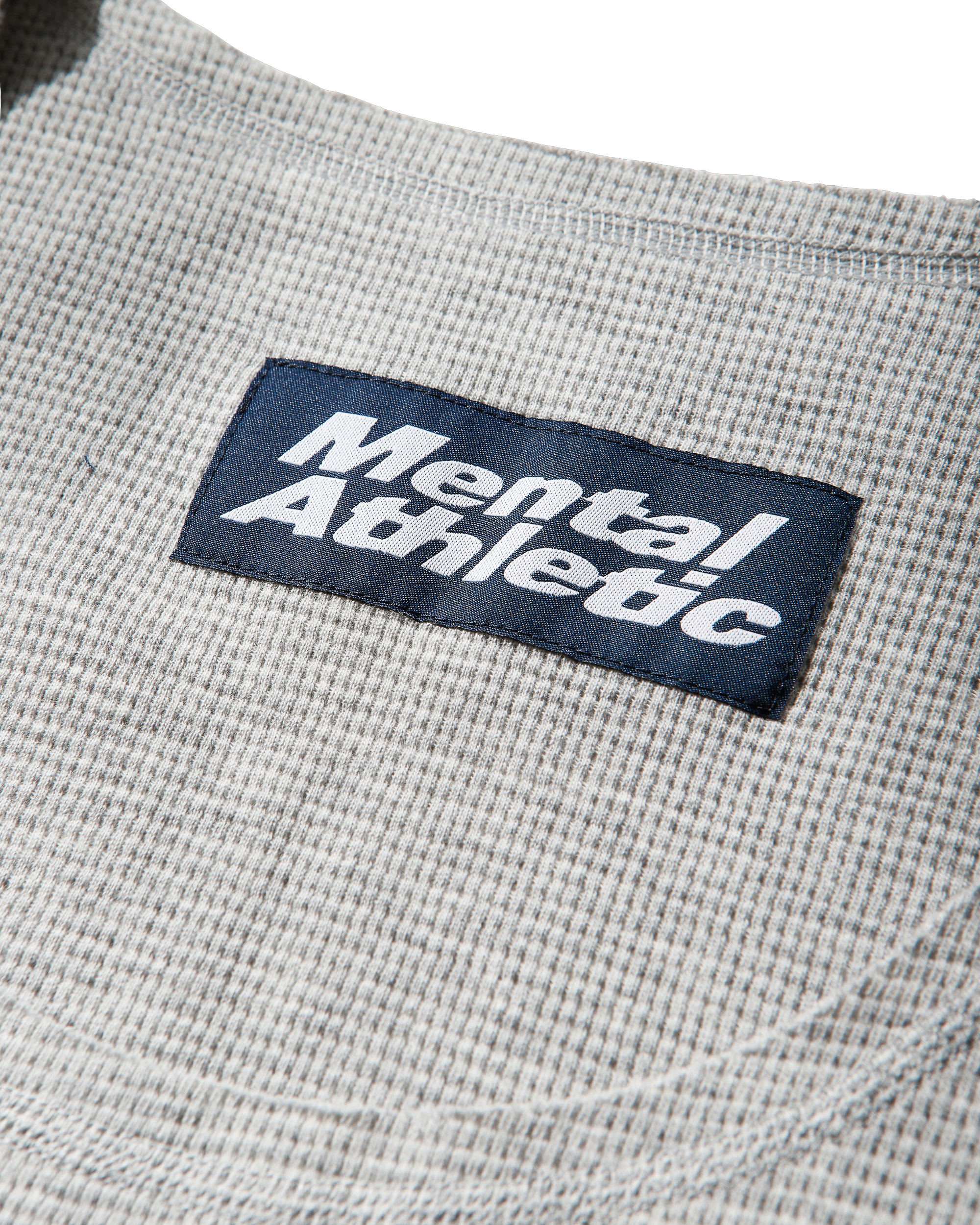 Mental Athletic grey cotton tank top detail of waffle fabric and woven label.