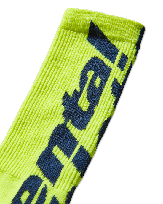 Mental Athletic neon yellow wool-blend socks detail of oversized woven logo on leg.
