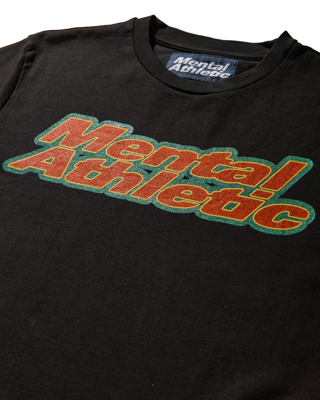 Mental Athletic x AFE black t-shirt detail of chest box logo in orange and green.