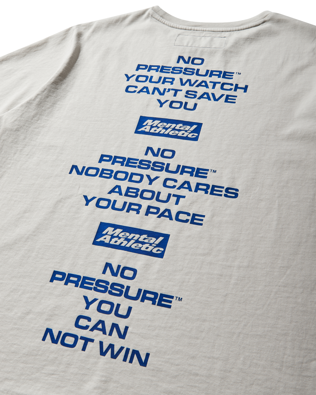 Mental Athletic x Pressure off-white t-shirt close-up of back text reading “No Pressure, Nobody Cares About Your Pace.”