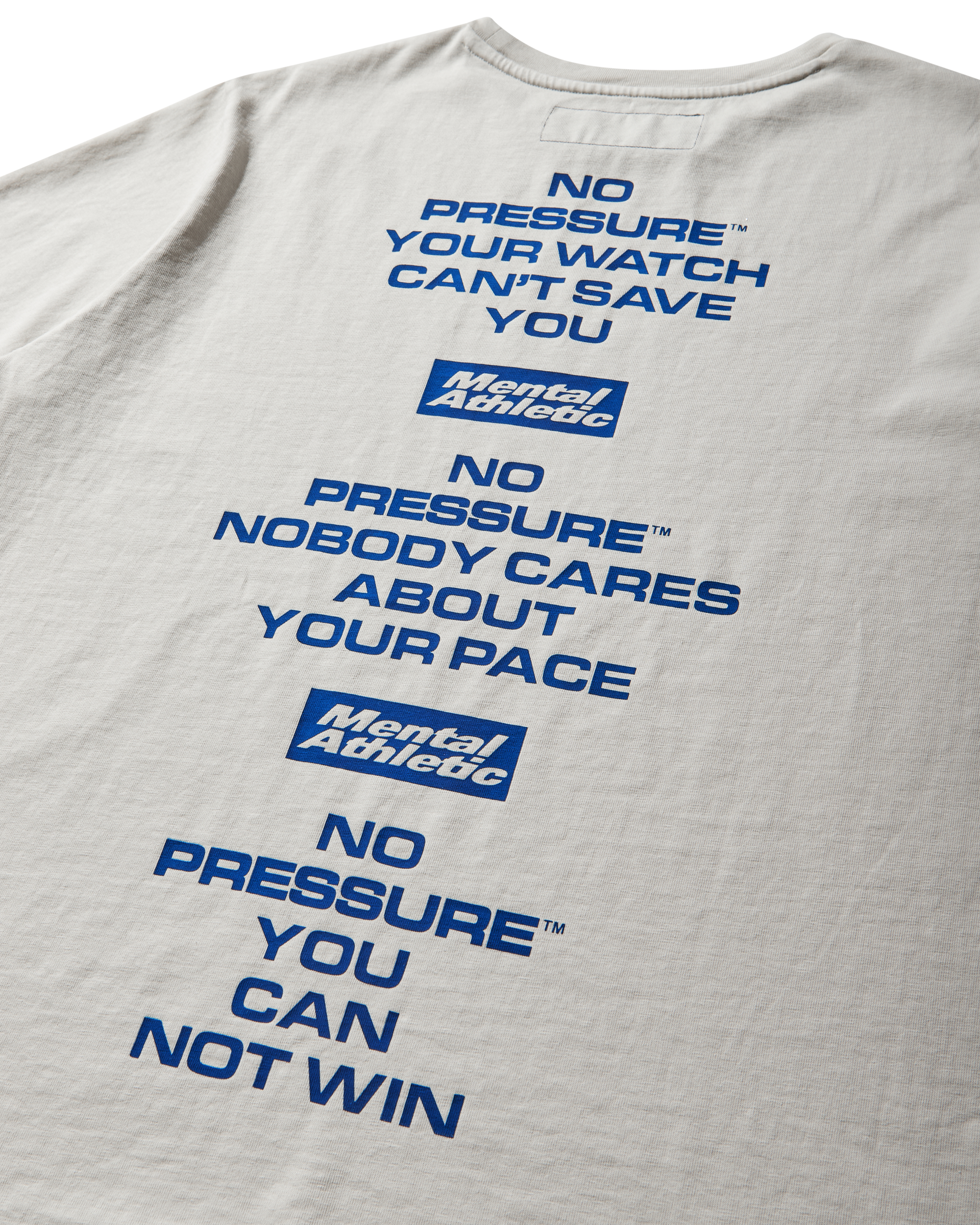 Mental Athletic x Pressure off-white t-shirt close-up of back text reading “No Pressure, Nobody Cares About Your Pace.”