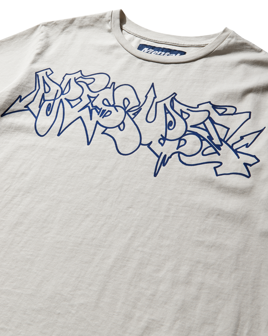 Mental Athletic x Pressure off-white t-shirt detail of graffiti-style logo print on chest.