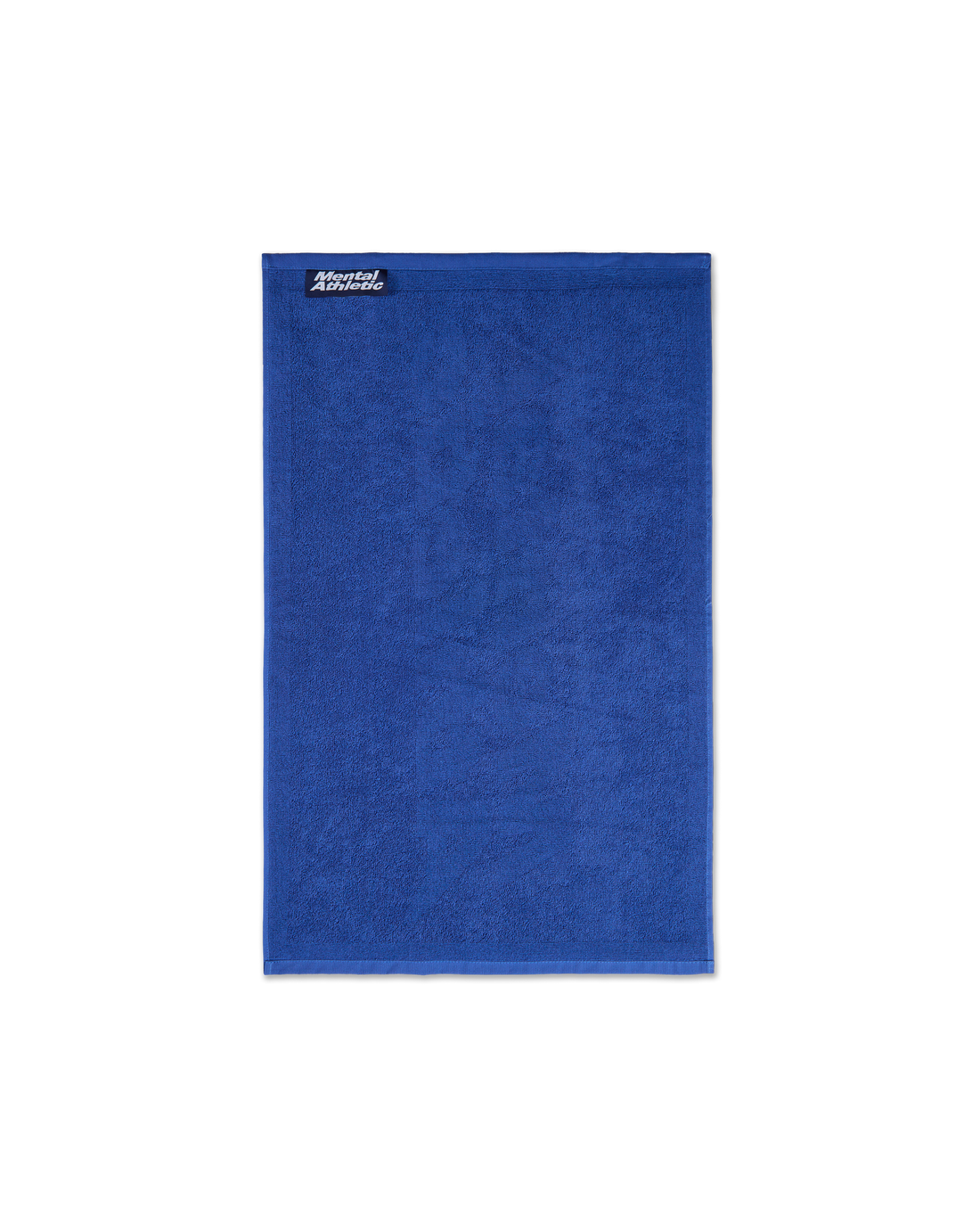 Full-length view of the small blue cotton terry towel with a tonal Mental Athletic jacquard design.