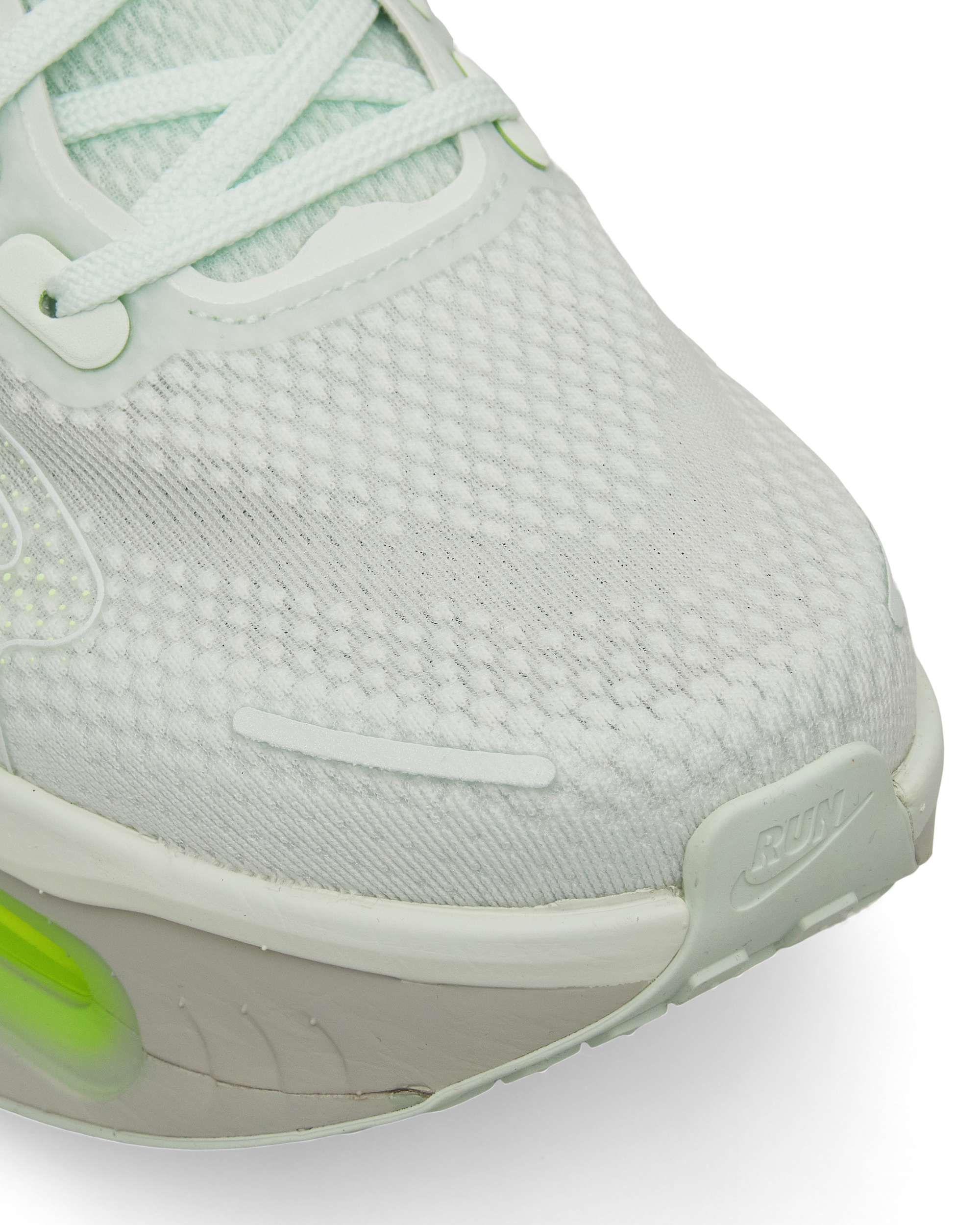 Close-up of breathable mesh upper with visible knit texture and lime detailing.
