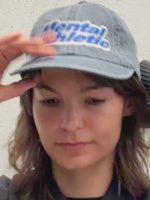 Mental Athletic washed blue cotton cap worn on head, lifestyle view.